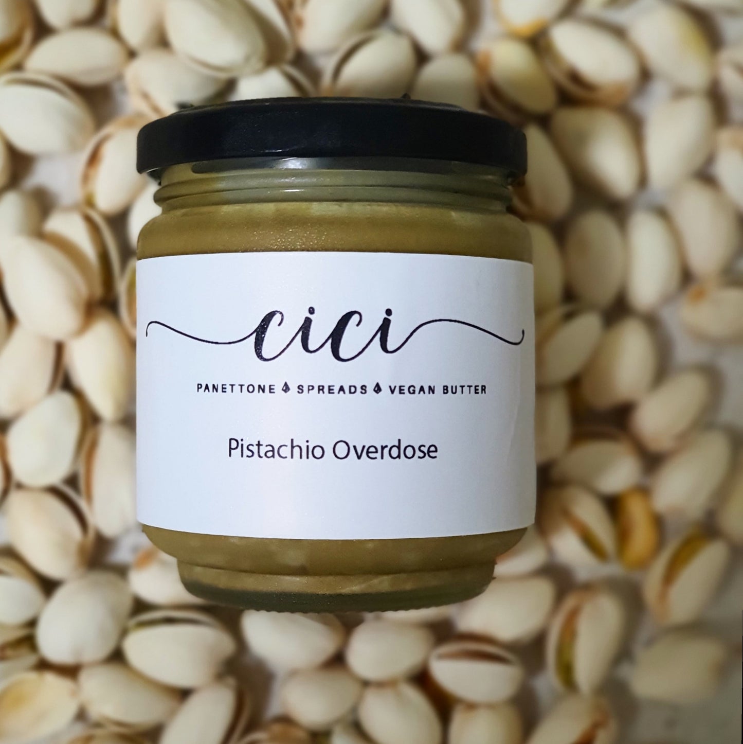 Creamy decandent pistachio nut spread with pistachio nuts at the background